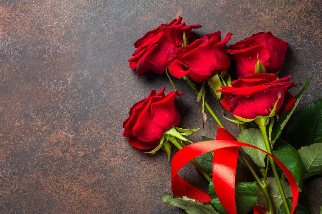 red roses on a dark stone table