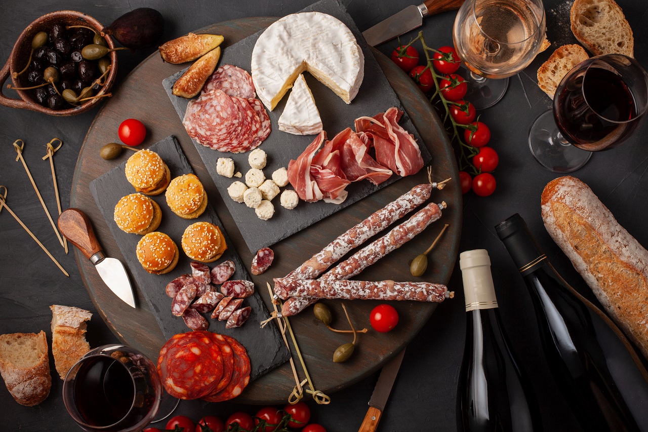 Charcuterie board of different types of meats, cheese, and pasta