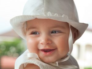 Close up of a baby girl in her baptismal attire