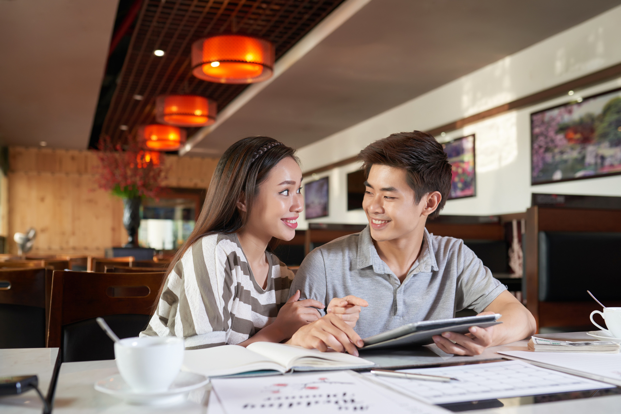 An engaged couple talking about wedding budget