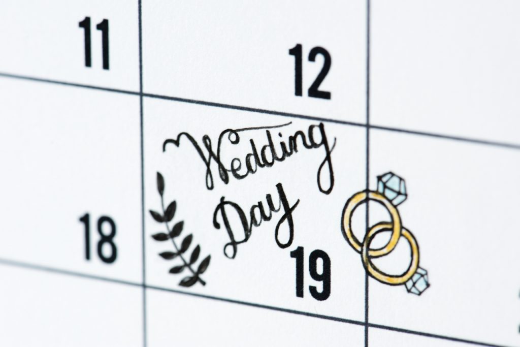 A calendar marking a couple's wedding date