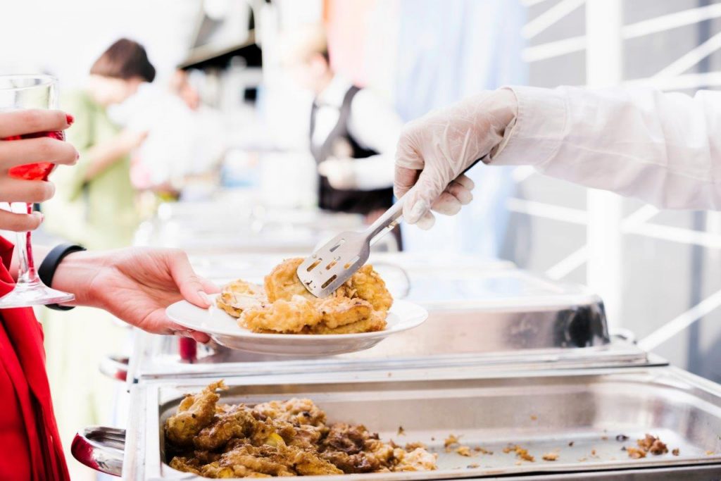 catering service serving food to wedding guests