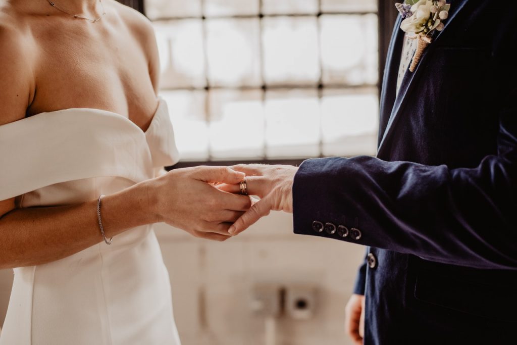 A couple saying their vows in an intimate wedding venue