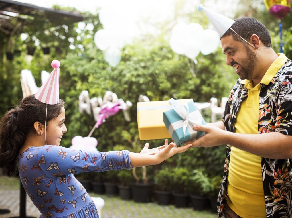 A man giving his daughter a gift for her birthday