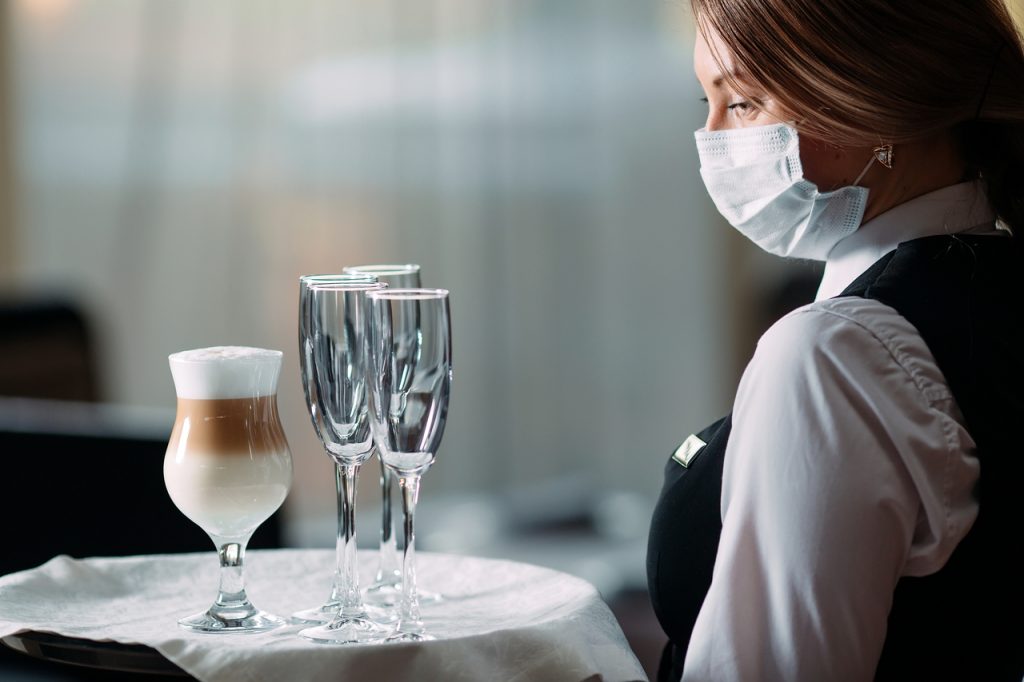 An event waiter with a face mask on